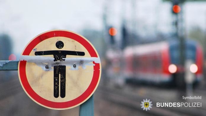 Zu Fuß im Gleisbereich - Zug kommt vor Person zum Stehen Zu Fuß im Gleisbereich - Zug kommt vor Person zum Stehen